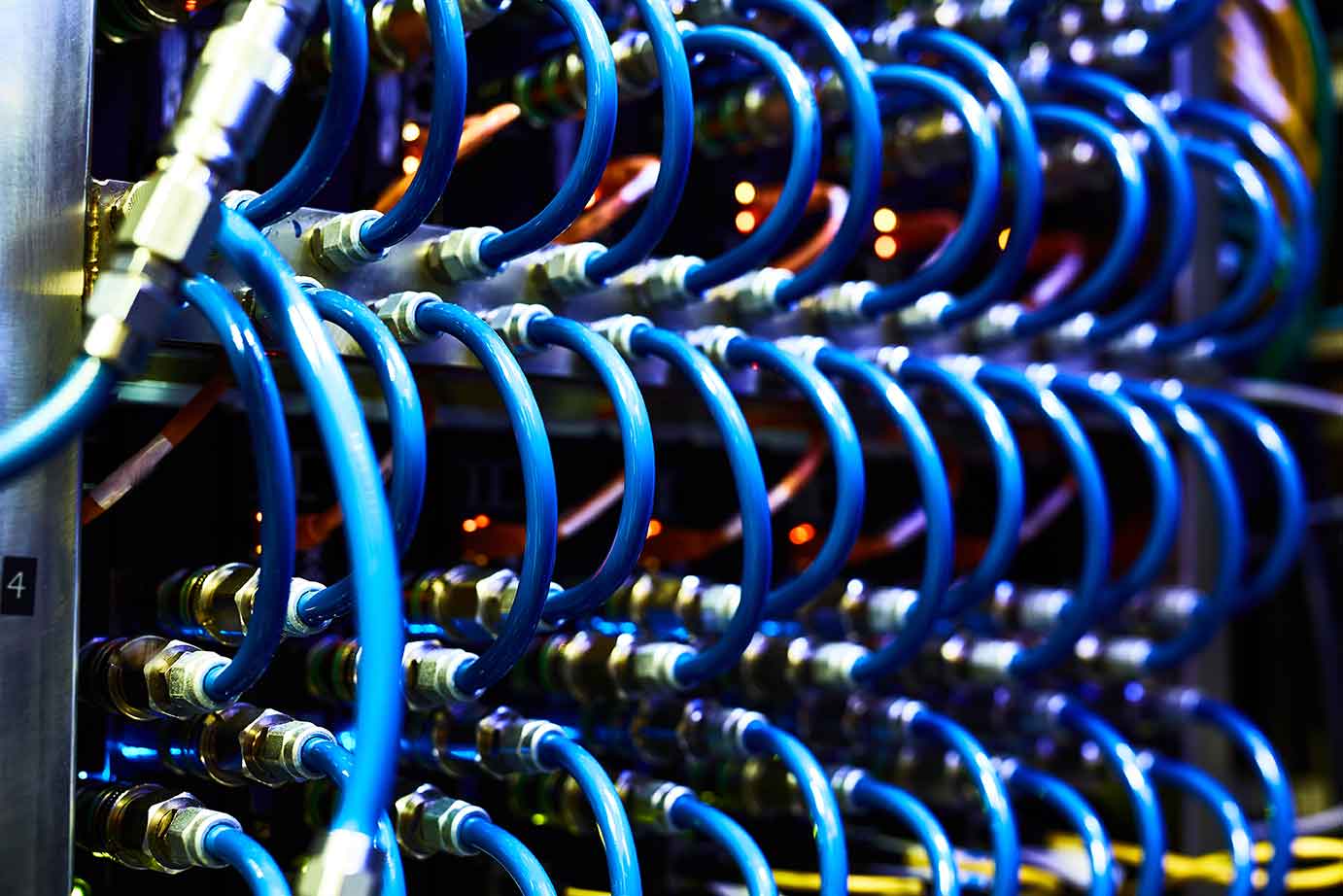 Blue network cables and connectors creating a structured cabling system, symbolizing the intricate connections in a data communication network.